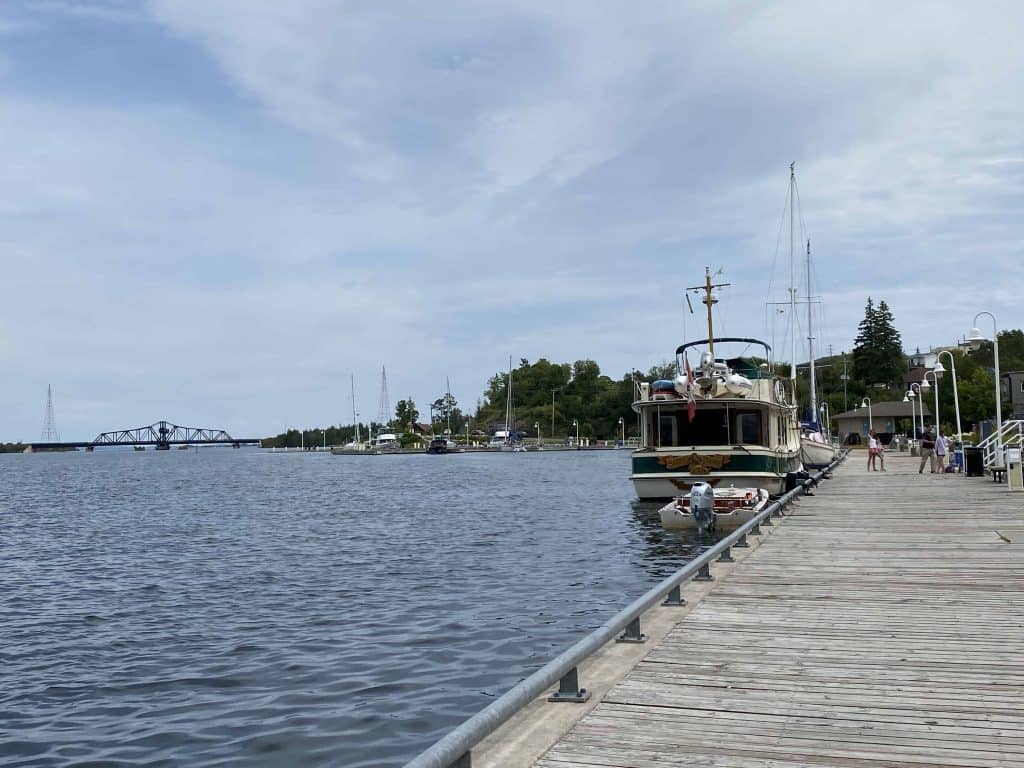 Little current waterfront on Manitoulin Island with boat and swing bridge in background.