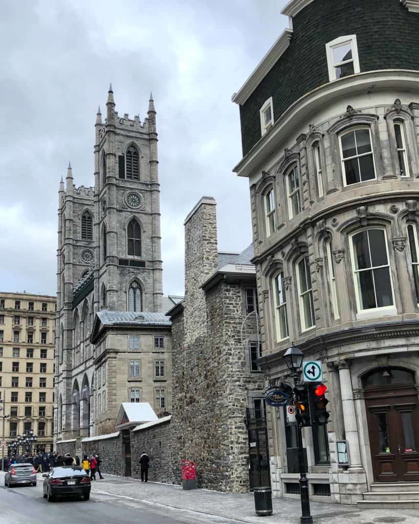 Street of old Montreal with view from side of Notre Dame Basilica.