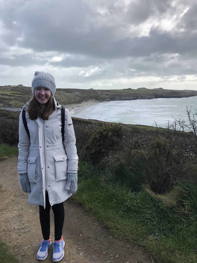 girl walking on wales coastal path