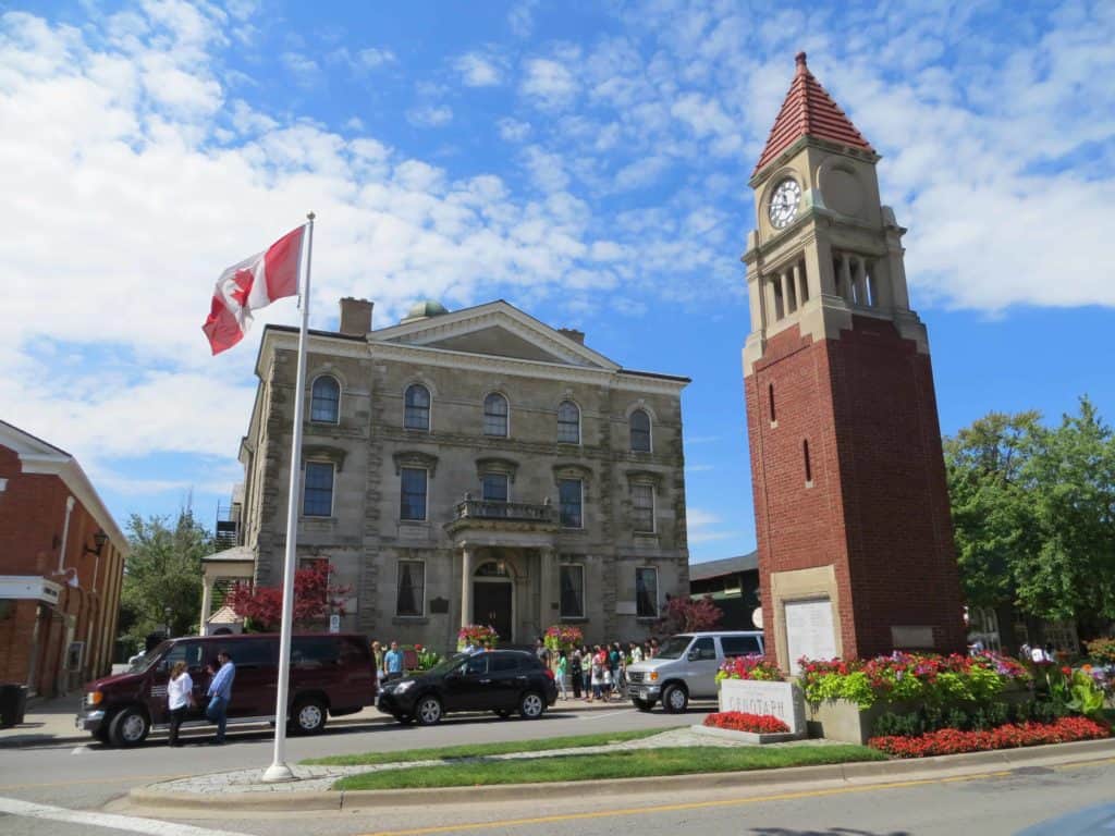 Queen Street in NOTL - Clock tower and Canadian flag in front of Old Courthouse.