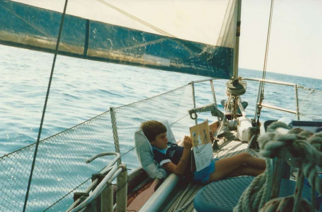 boy reading on sailboat