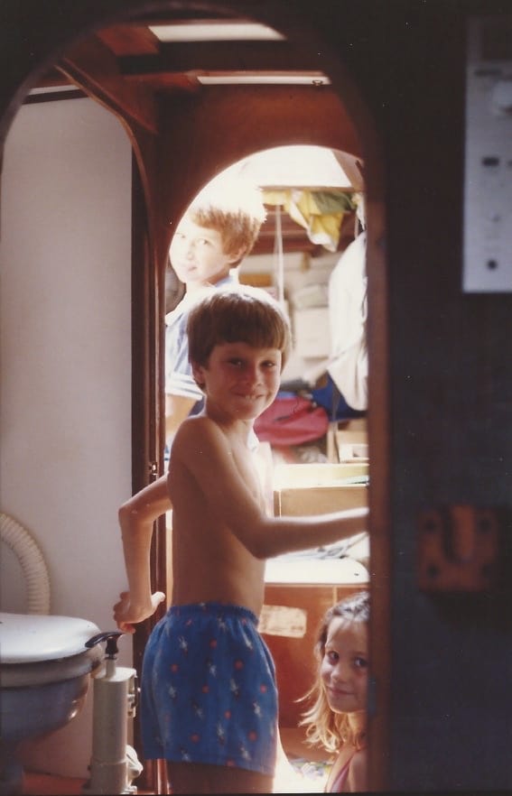 children playing in cabin of sailboat