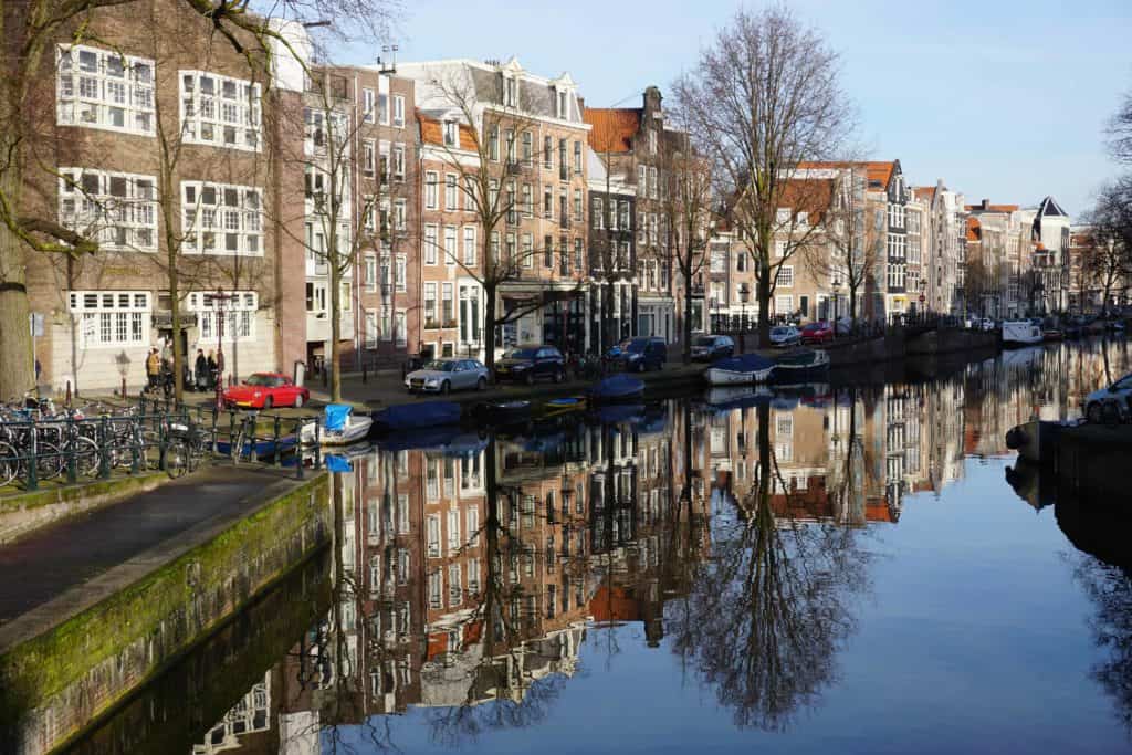 Reflections of buildings in the canal in Amsterdam during spring break. 