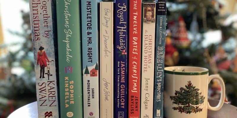 christmas novels and must on table in front of christmas tree