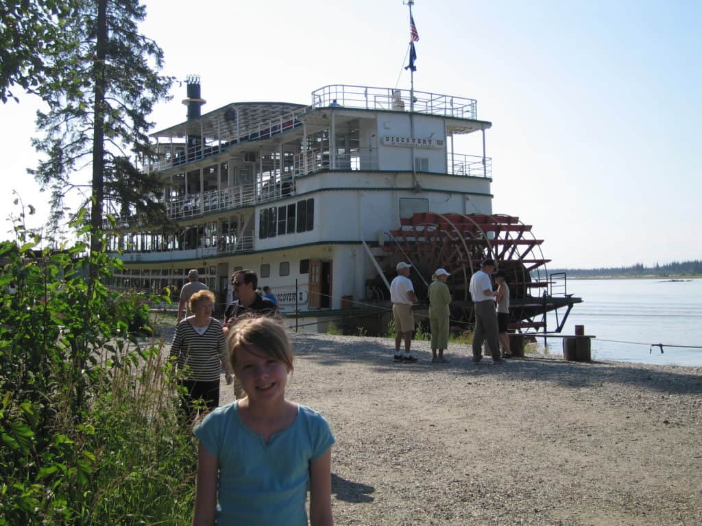 young girl by riverboat in fairbanks, alaska