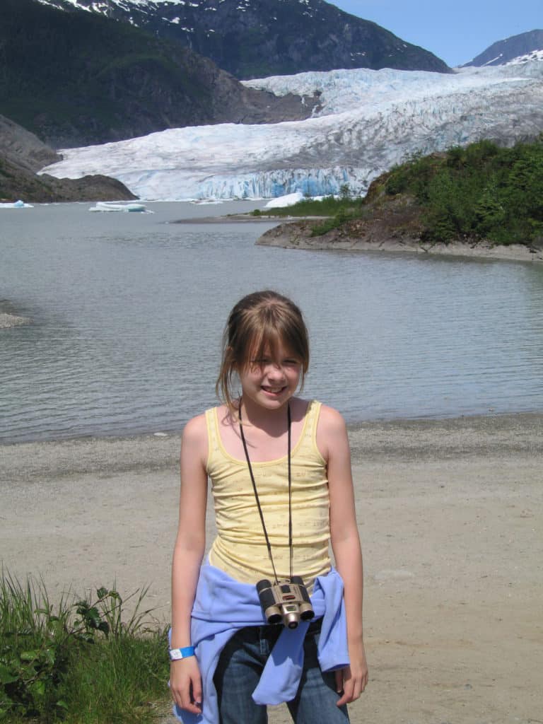 juneau-alaska-girl in yellow tank top wearing binoculars at mendenhall glacier