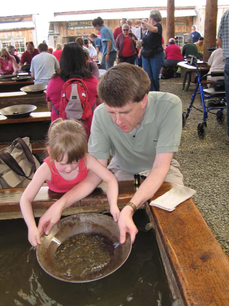 young girl and dad panning for gold at el dorado mine in fairbanks, alaska
