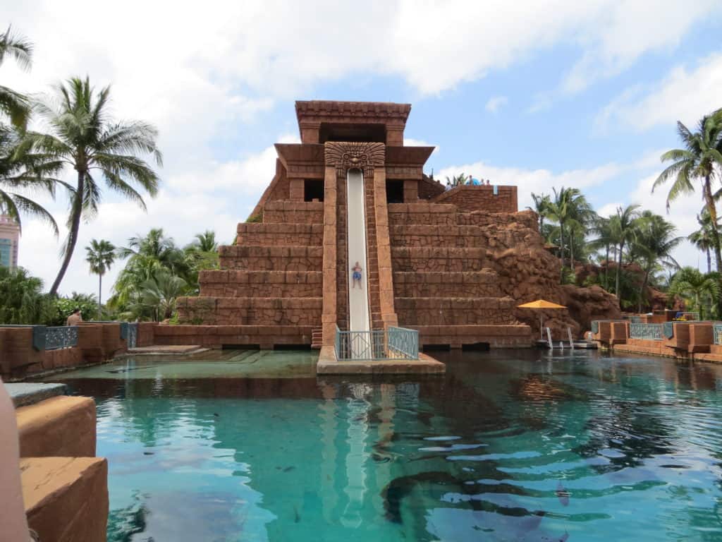 man sliding on leap of faith waterslide at atlantis resort in bahamas.