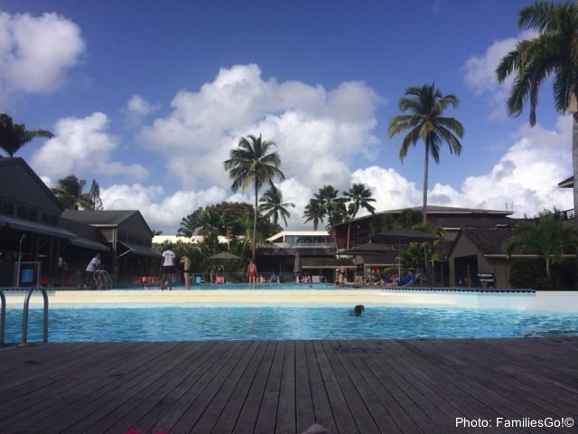 People relaxing around pool at La Creole Beach Club Hotel in Guadeloupe.