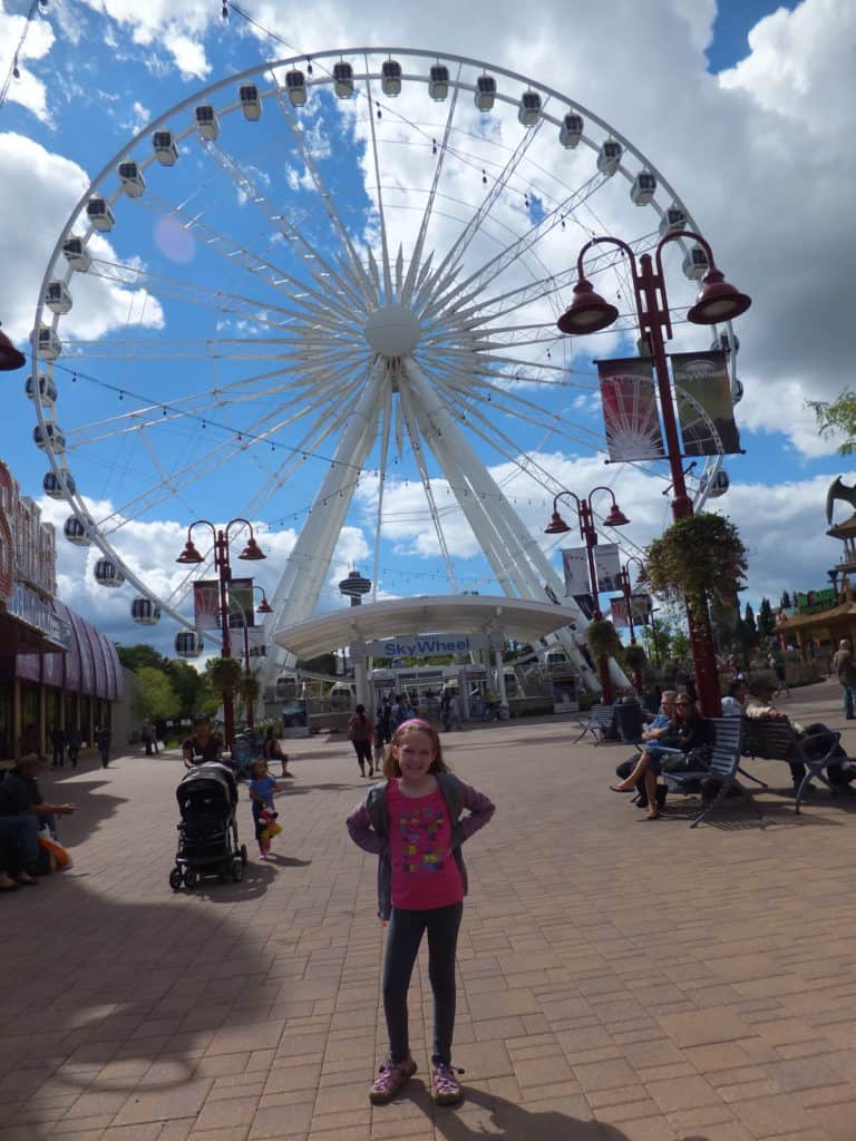 Young girl in front of the Niagara Skywheel on a family vacation in Niagara Falls, Canada.