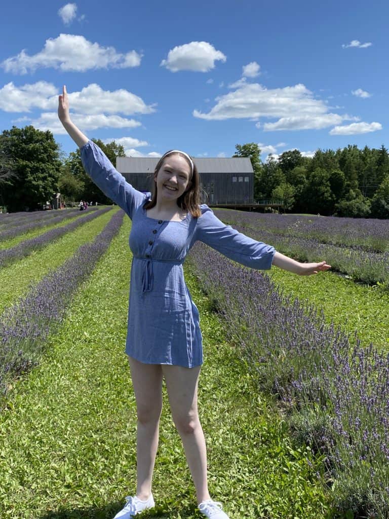 Young woman posing in lavender fields at Terre Bleu Lavender Farm.