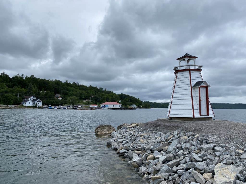 Lighthouse on breakwater overlooking village of Kagawong, Manitoulin Island.