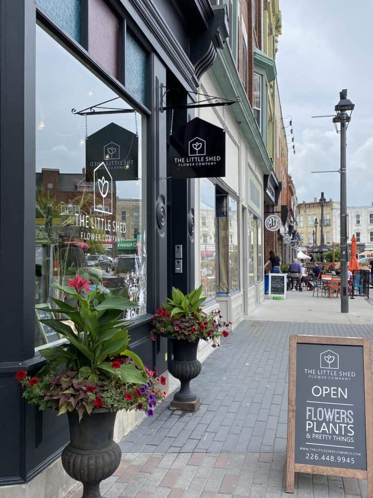 Shops along sidewalk in Stratford Ontario in summer.