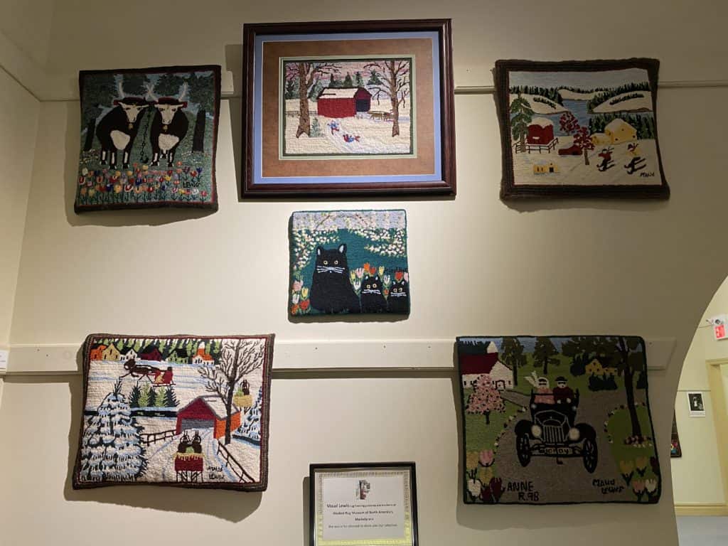 Hooked rugs depicting Maud Lewis paintings at Hooked Rug Museum of North America in Nova Scotia.