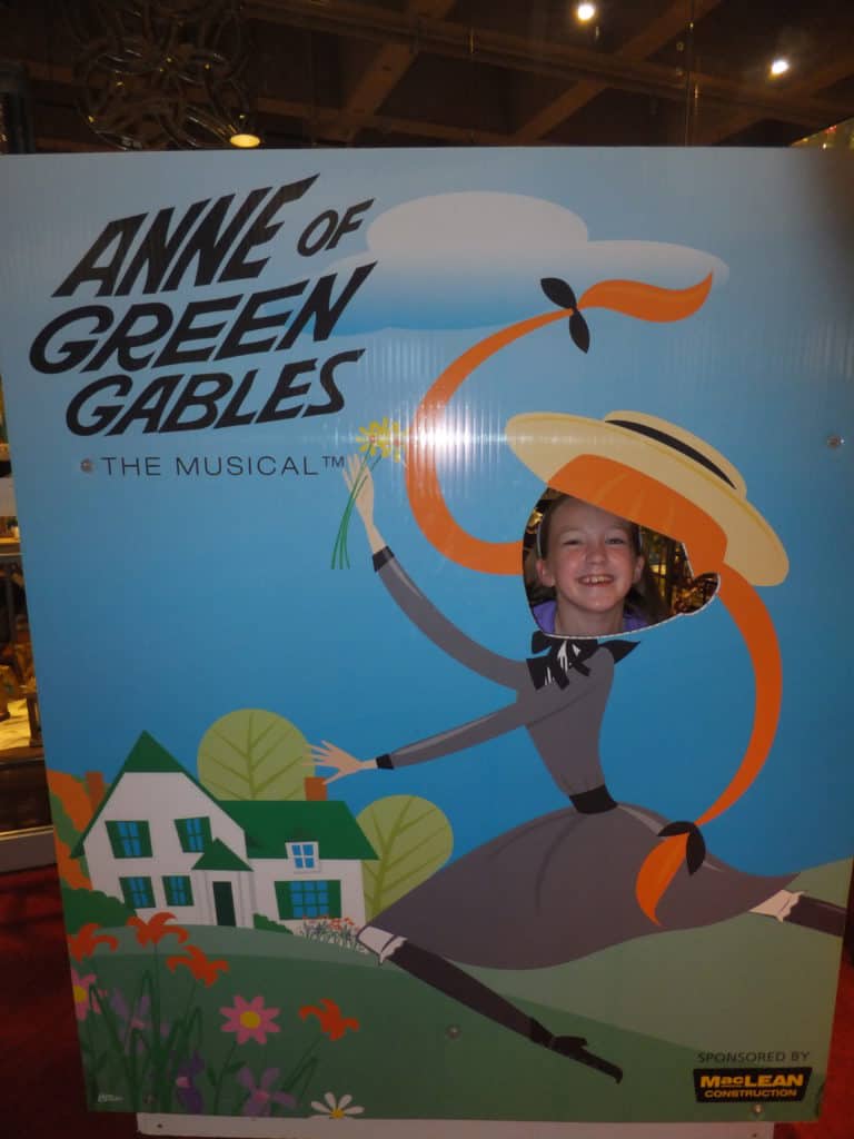 Young girl with face in an Anne of Green Gables The Musical cut-out at the Confederation Centre in Charlottetown, PEI.