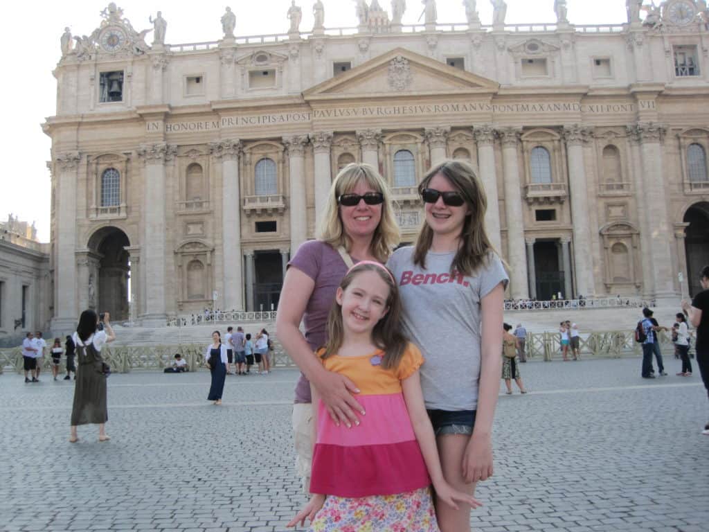 Woman and two girls posing outside St. Peter's Basilica in Rome, Italy.