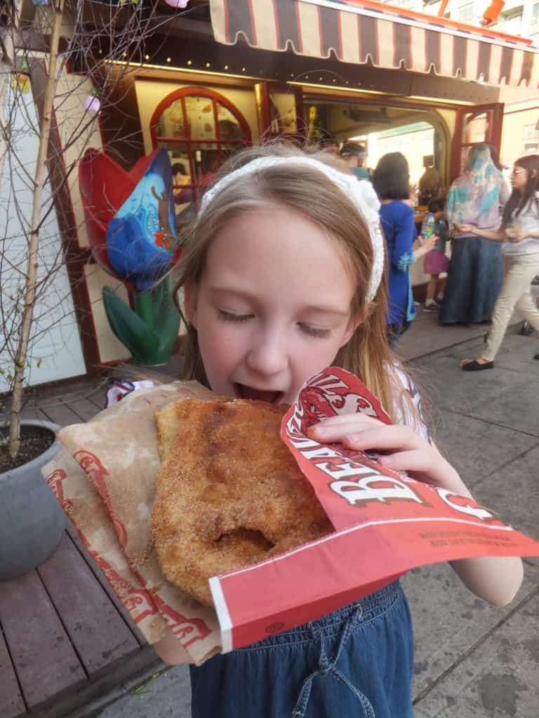Young girl enjoying a BeaverTail pastry in Ottawa, Canada.