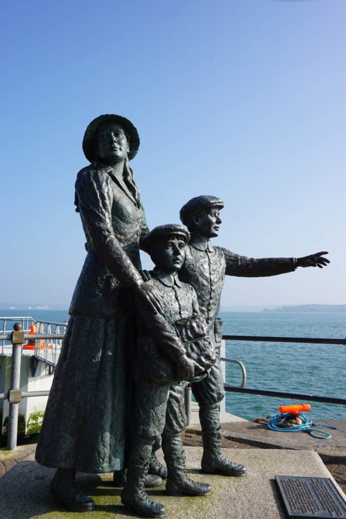 Annie Moore emigration sculpture in Cobh, Ireland - young woman and two young boys looking out to sea.