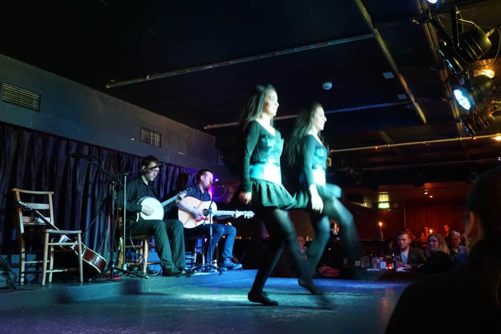 Irish dancing performance in Dublin, Ireland - two women dancing with musicians seated in background.