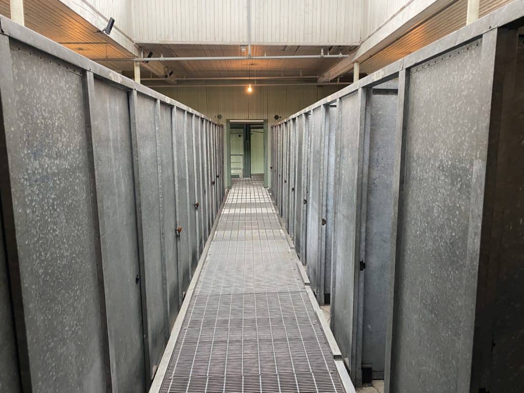 corridor lined with metal shower stalls at Grosse-Ile, Québec