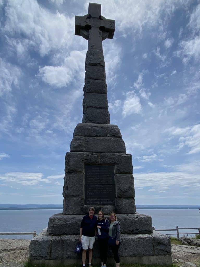 Family standing in front of the Celtic Cross, Grosse-Île, Québec