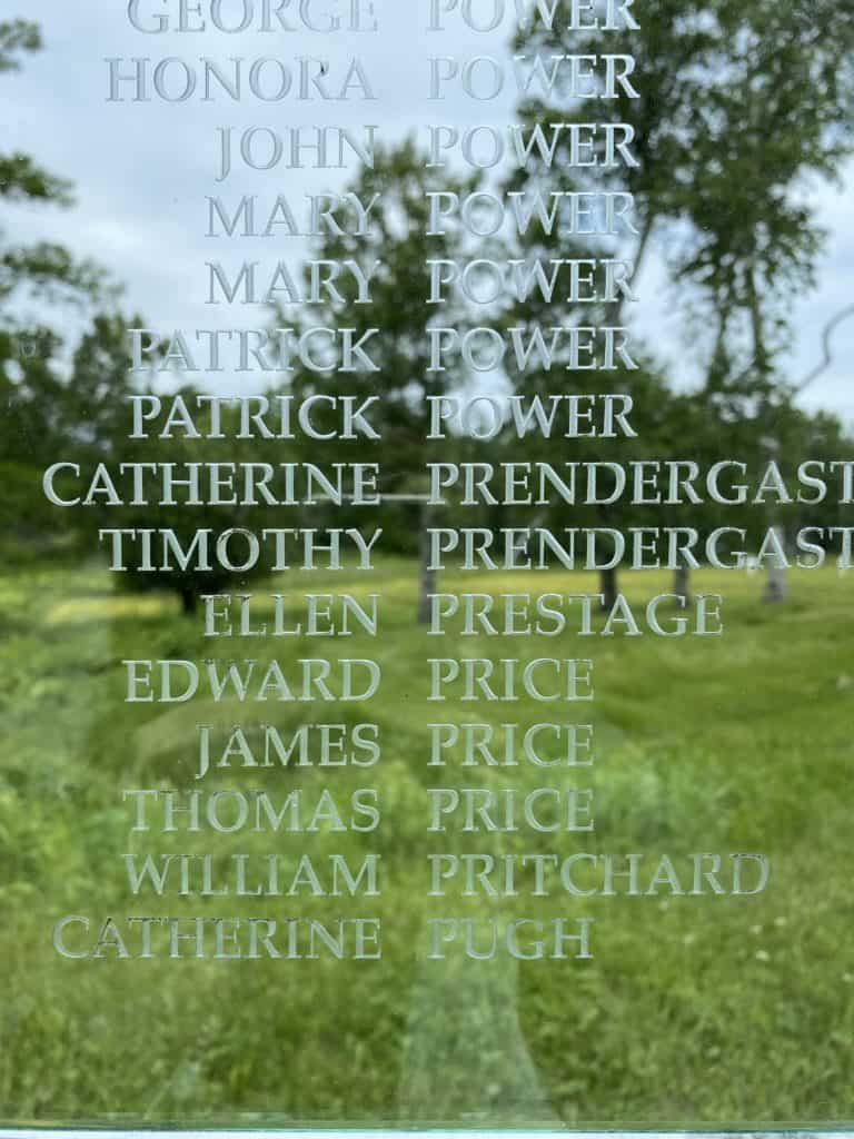 Names of some of those who died at Grosse-Île, Québec etched in glass on memorial.