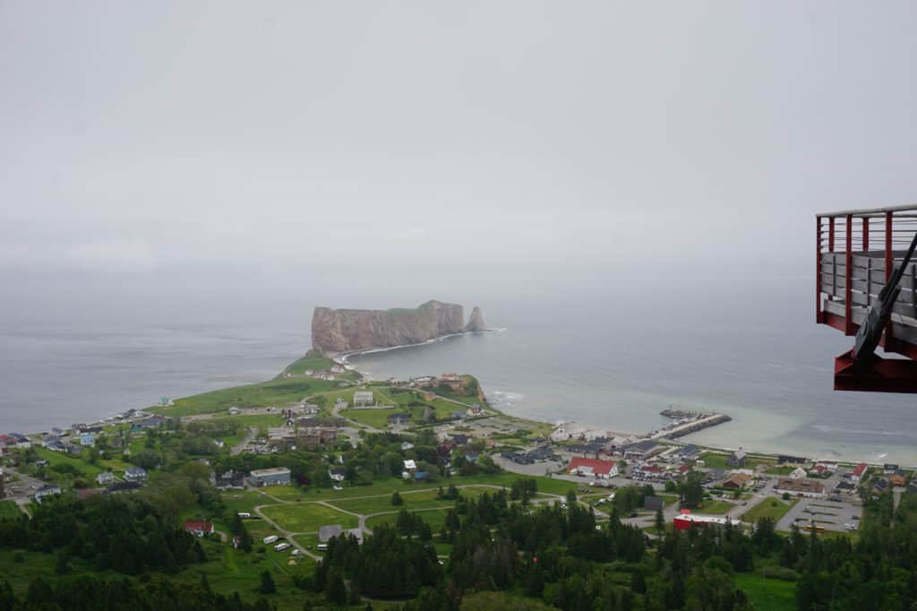View of Perce Rock and village from Geopark summit with edge of glass platform.