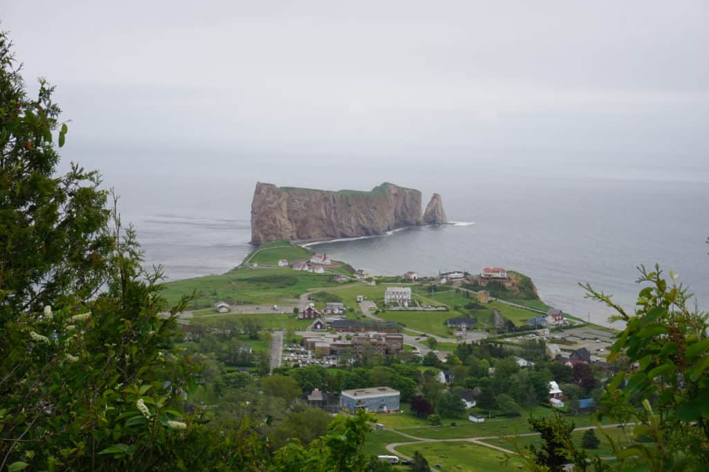 View of Perce Rock and the village of Perce in light fog from the Geoparc