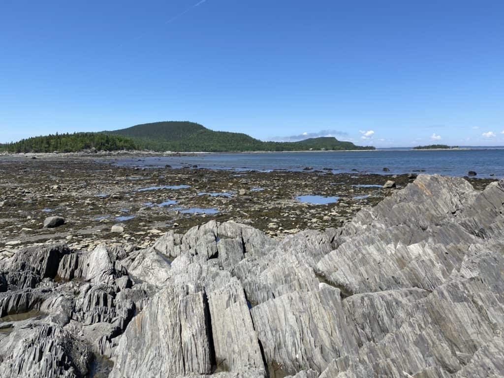 Rocky coastline of St. Lawrence River at low tide in Bic National Park, Quebec.