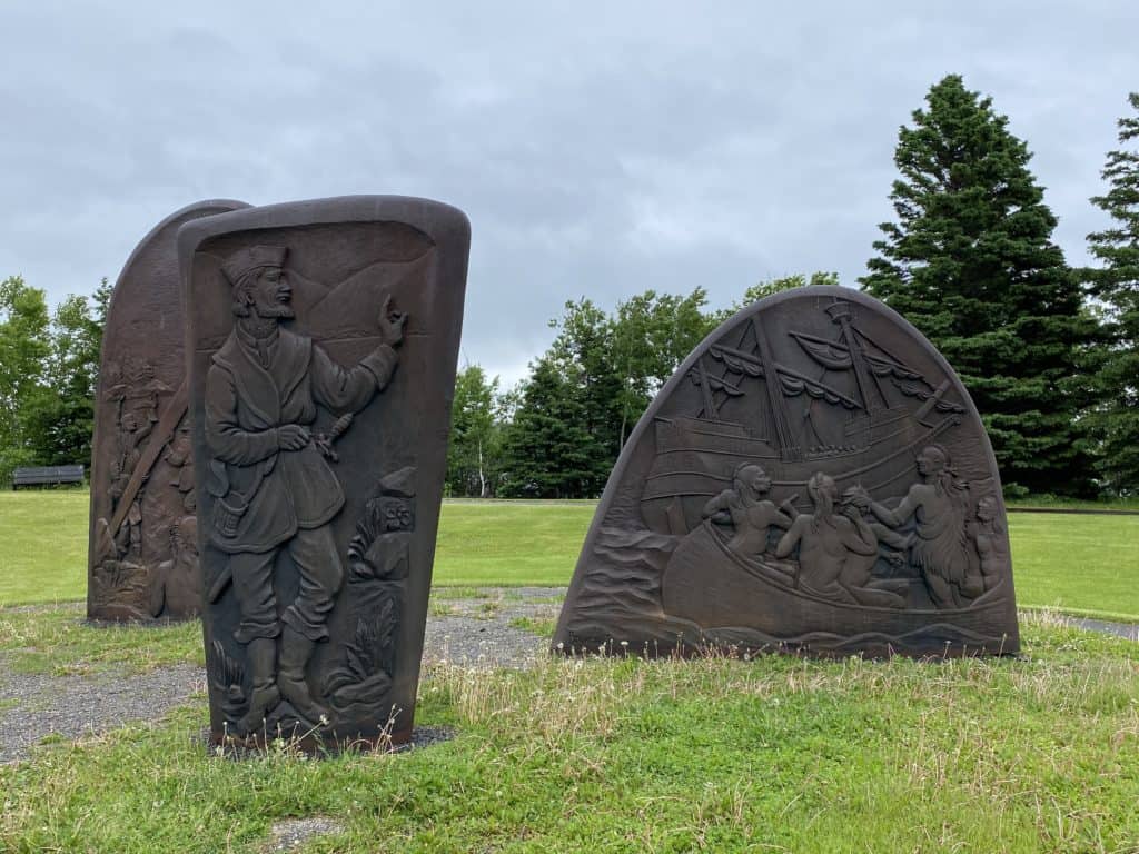 three large cast-iron slabs depicting Jacques Cartier meeting St. Lawrence Iroquoians in 1534.