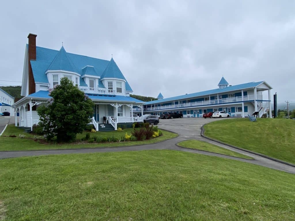 white motel with blue roof in Gaspe, Quebec