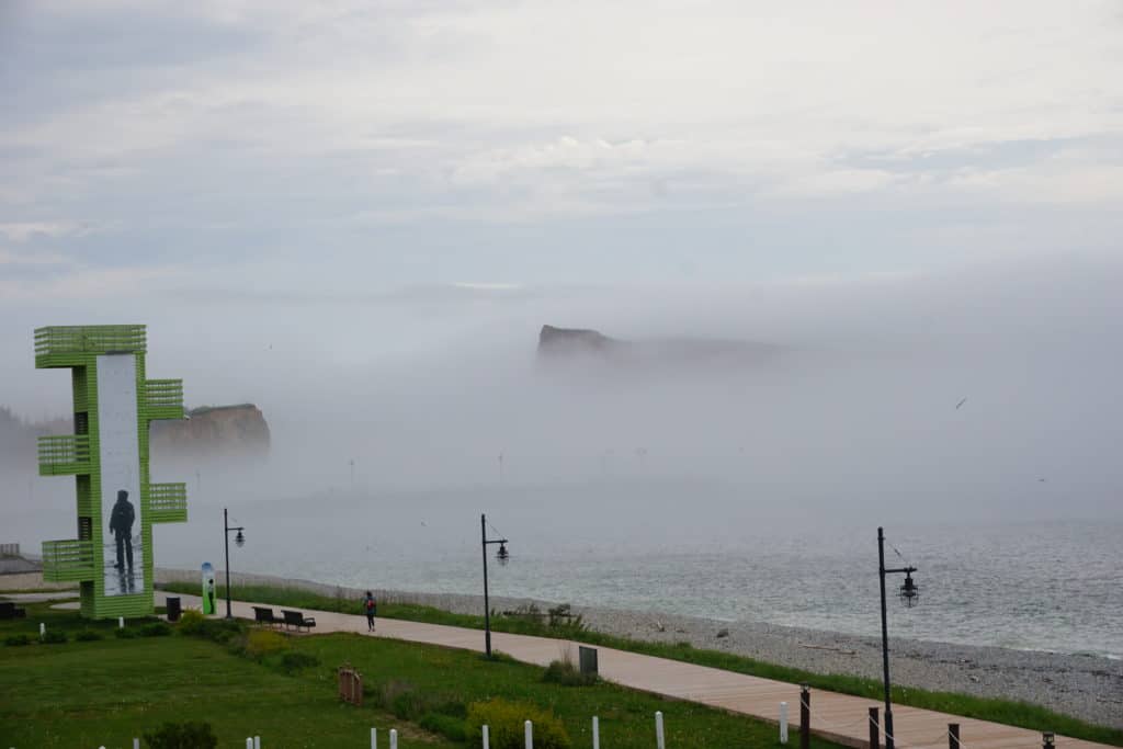 View of Perce Rock shrouded in fog from balcony of La Normandie Hotel.
