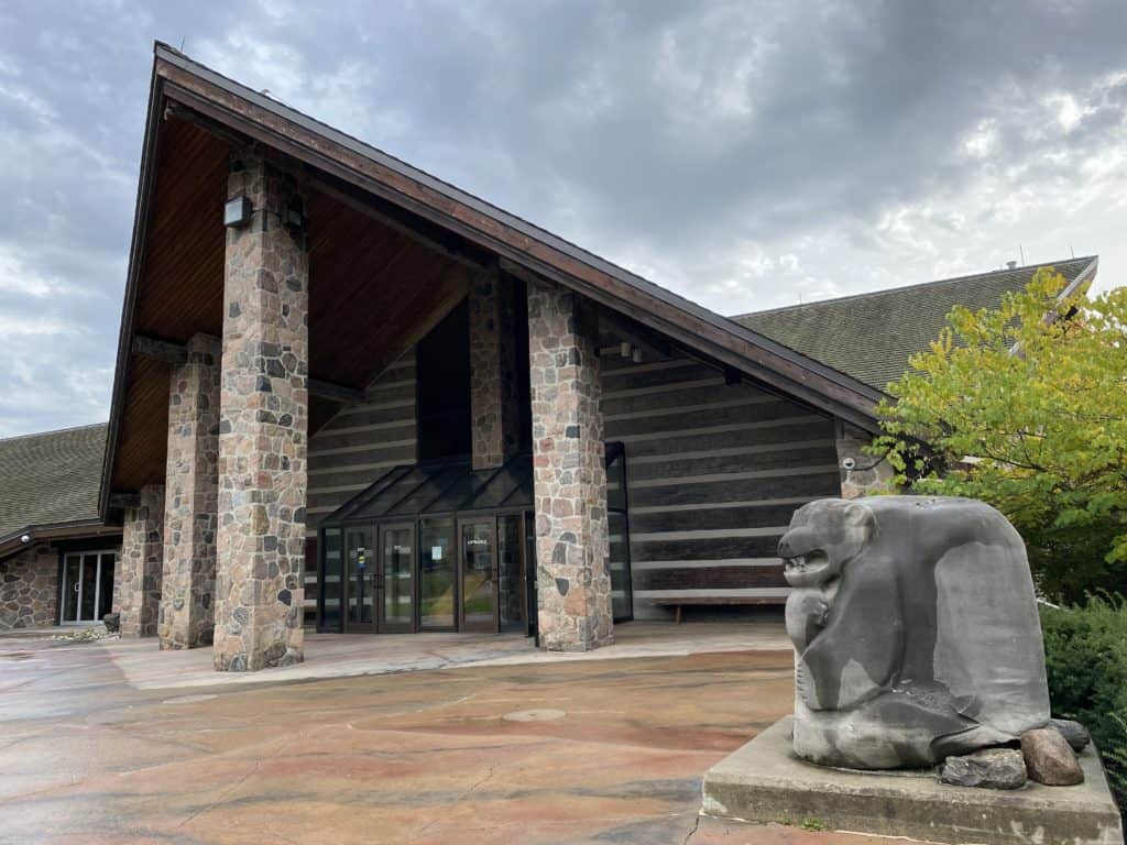 Exterior of McMichael Gallery with sculpture in foreground.