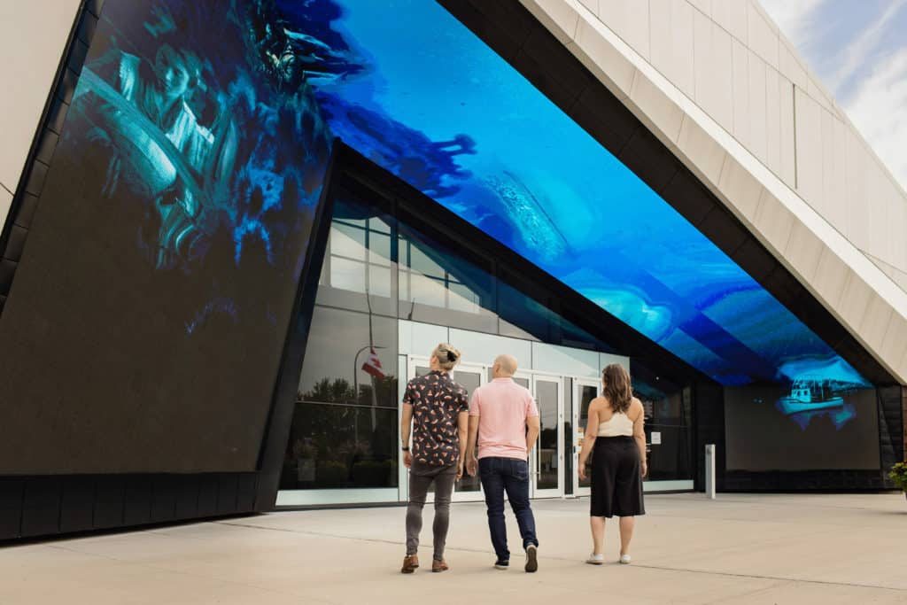 Three adults standing outside the Canada Science and Technology Museum.