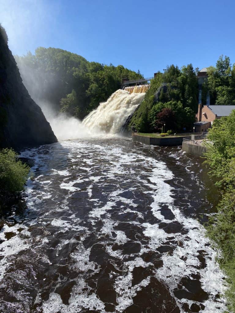 waterfall at Parc des Chutes in Riviere-du-Loup, Quebec with blue sky on bright sunny morning.