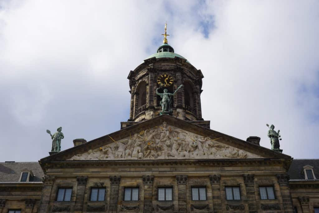 Clock tower at top of Royal Palace in Amsterdam.