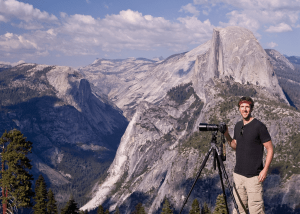 Man with camera set up on tripod in Yosemite National Park.