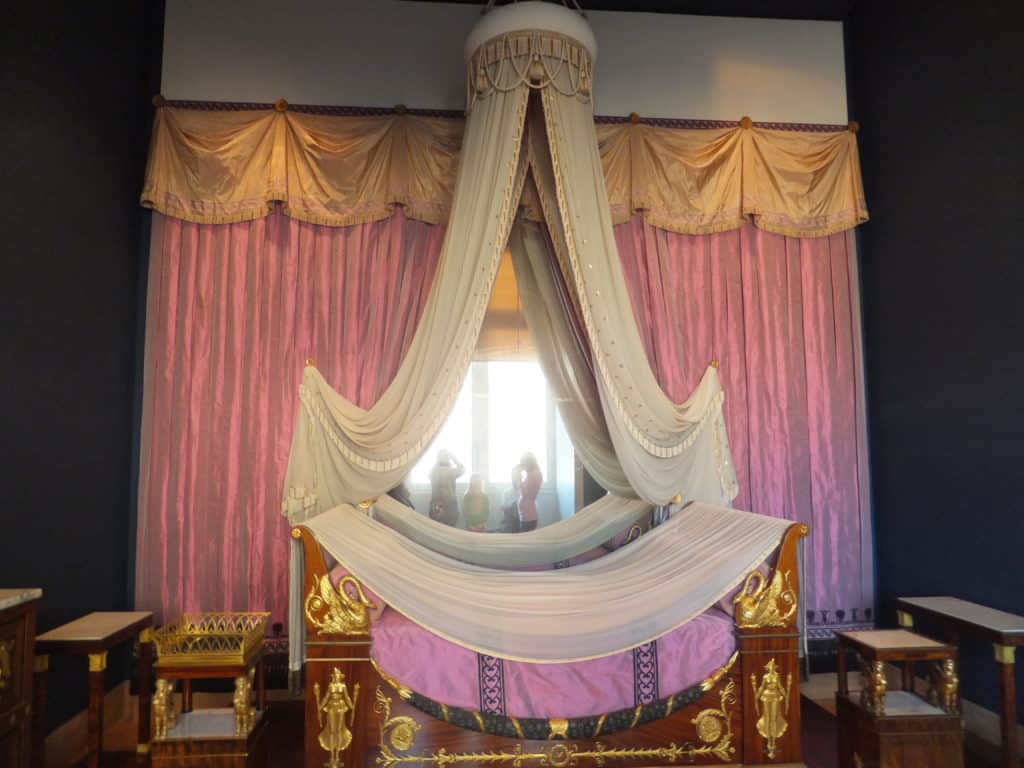 Elaborate pink bed and curtains in Napoleon apartments at the Louvre.