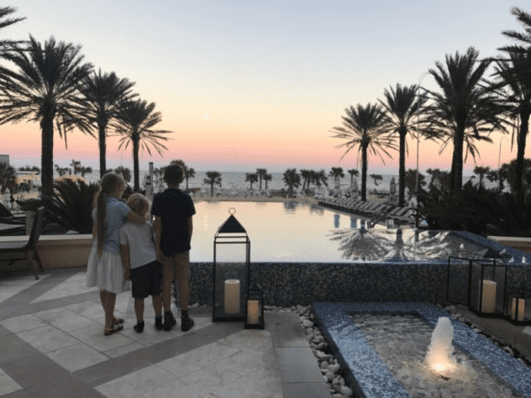 Three children watching the sunset at Omni Amelia Island Resort in Florida.