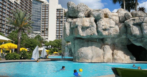 Kids playing with yellow ball in pool at Hyatt Regency Grand Cypress.