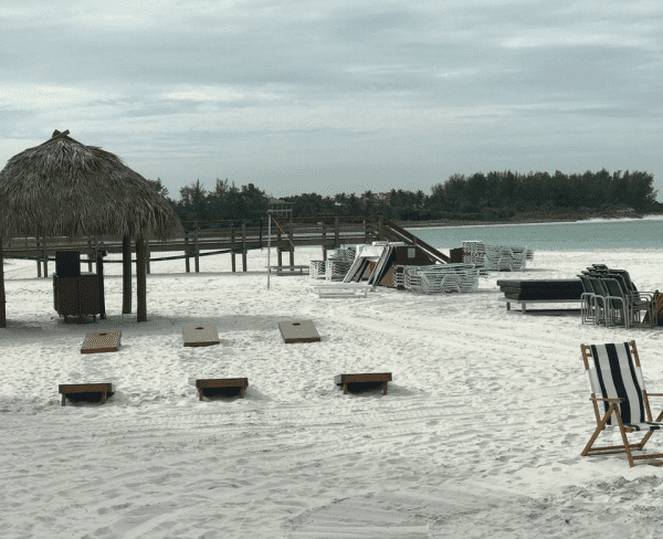 Stacked beach chairs on sandy beach at the Resort at Longboat Key Club in Sarasota, Florida.