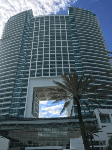 The Diplomat Beach Resort Hollywood tower with palm tree in front.