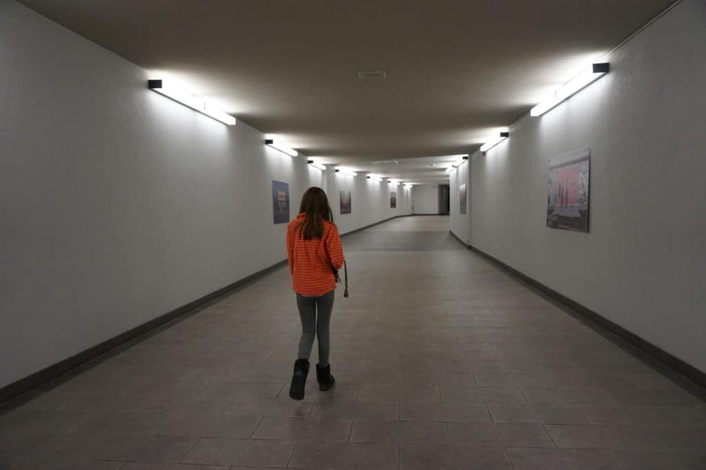 Young girl in pink shirt walking in Montreal's underground city.