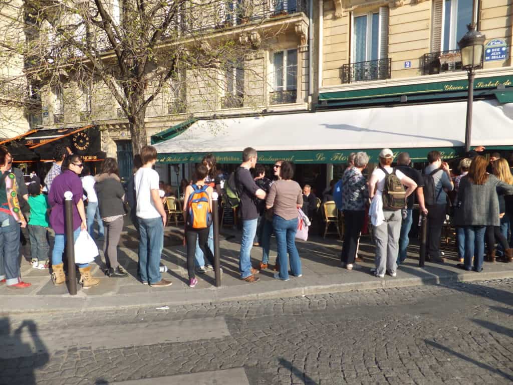 Line of people outside Berthillon ice cream shop in Paris, France.