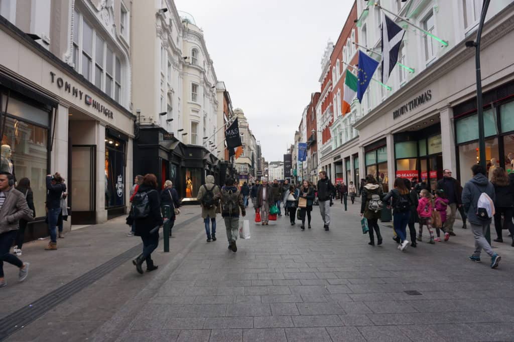 Pedestrians walking by shops on Grafton Street, Dublin, Ireland.