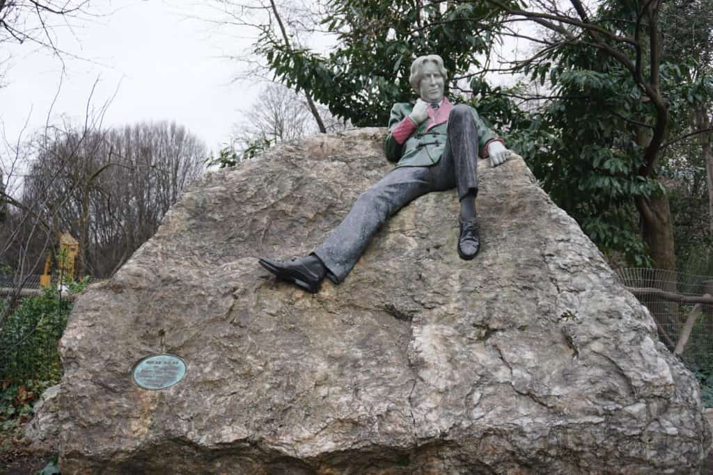 Oscar Wilde Memorial Sculpture in St. Stephen's Green - sculpture of man lounging on large rock.