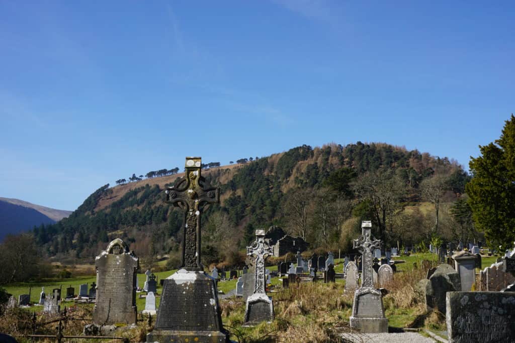 Celtic crosses and other stones in cemetery at the Monastic City in Glendalough, Ireland.