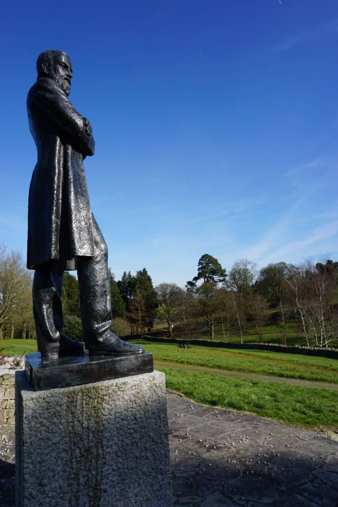 Bronze statue of Charles Parnell against bright blue sky in Rathdrum, County Wicklow, Ireland.