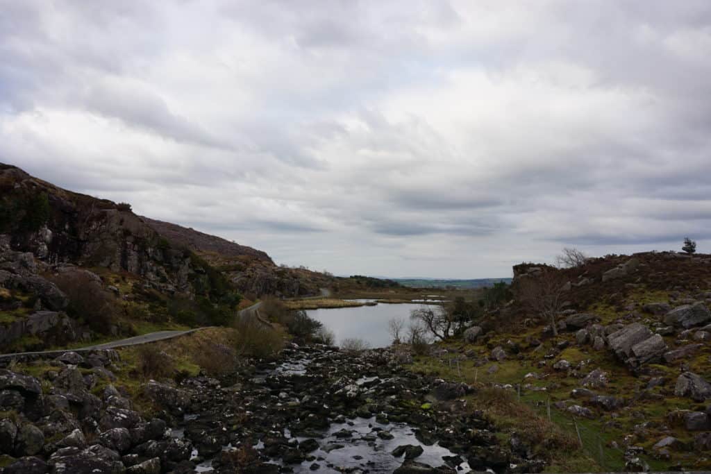 Small lake surrounded by rocks and hills in Killarney National Park, Ireland.