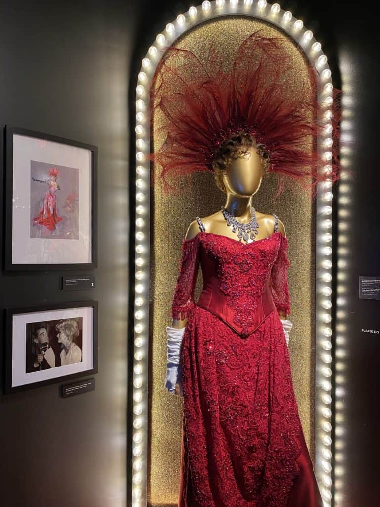 Display of red dress and hairpiece from Hello Dolly.